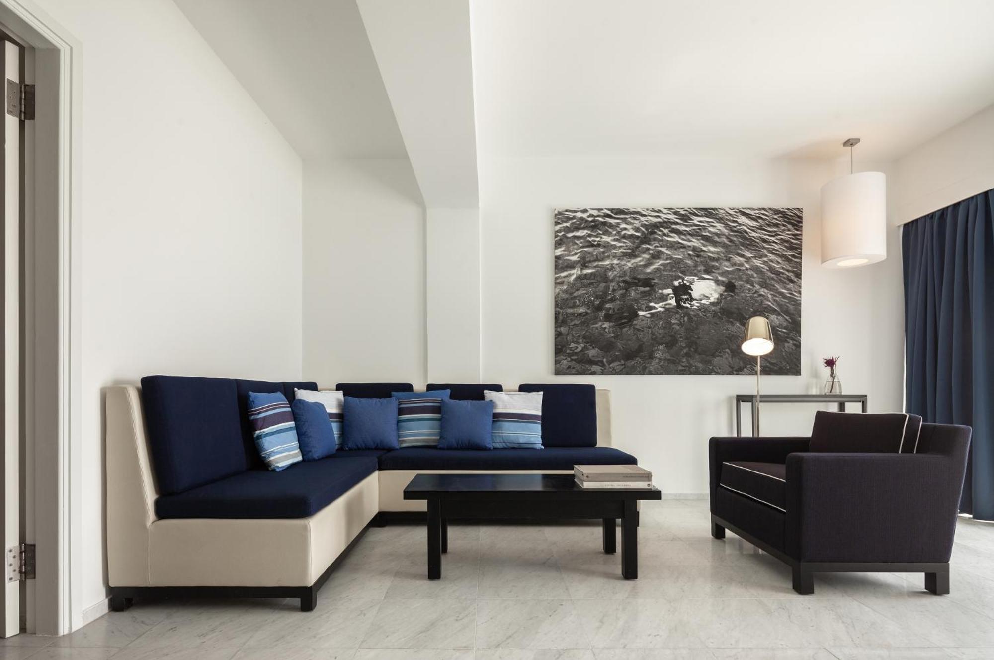 Almyra Hotel Paphos Exterior photo A living room with a sectional sofa